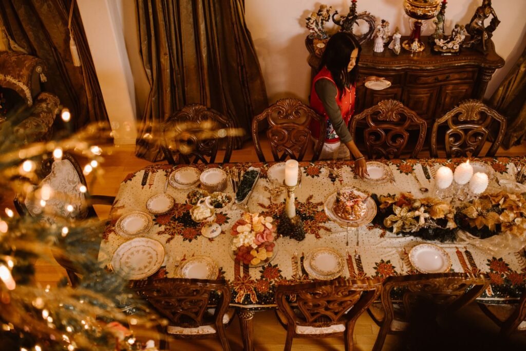 A festive dinner table set with porcelain plates, candles and holiday decorations