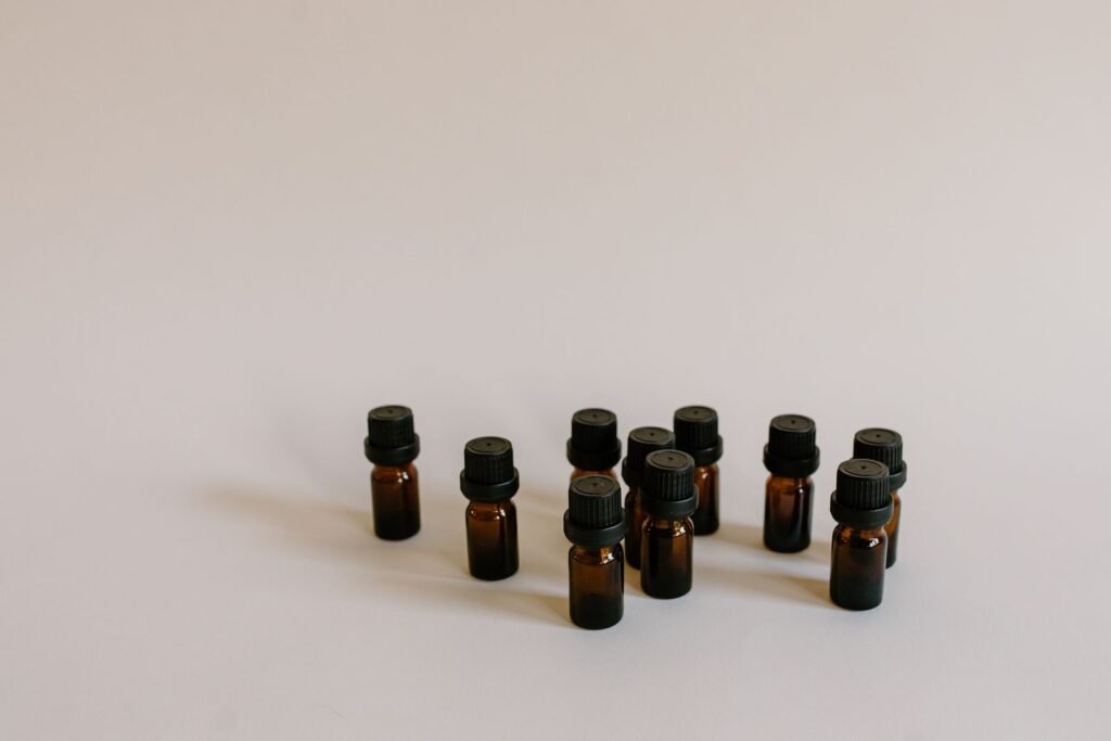 A group of small brown essential oil bottles standing on a pale surface